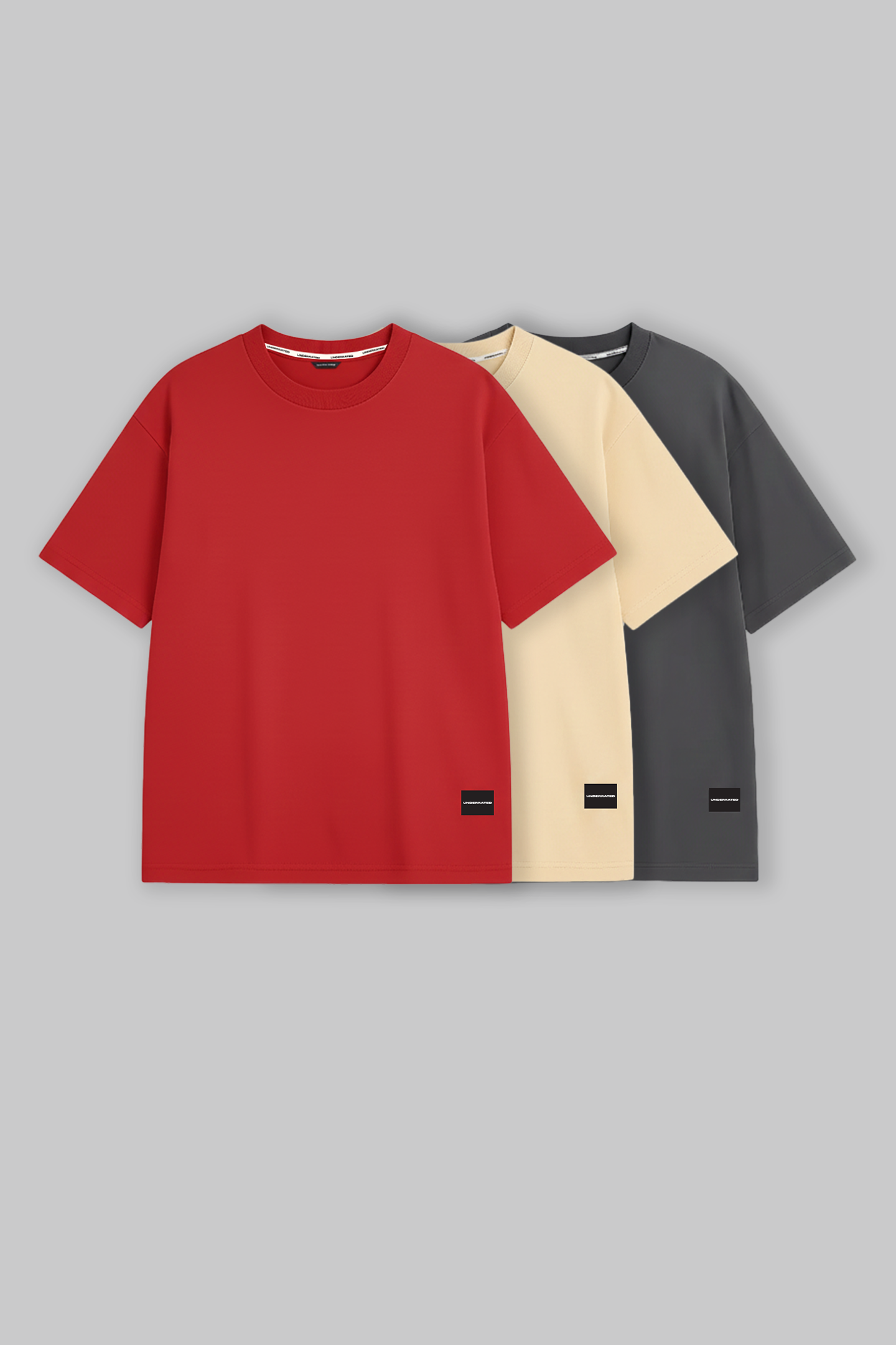 UNDERRATED oversized red t-shirt with brand tag on grey background - men's streetwear essential.
