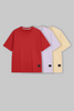UNDERRATED oversized t-shirts trio in red, lavender purple, and beige colors with brand tags against grey background - men's streetwear collection.

