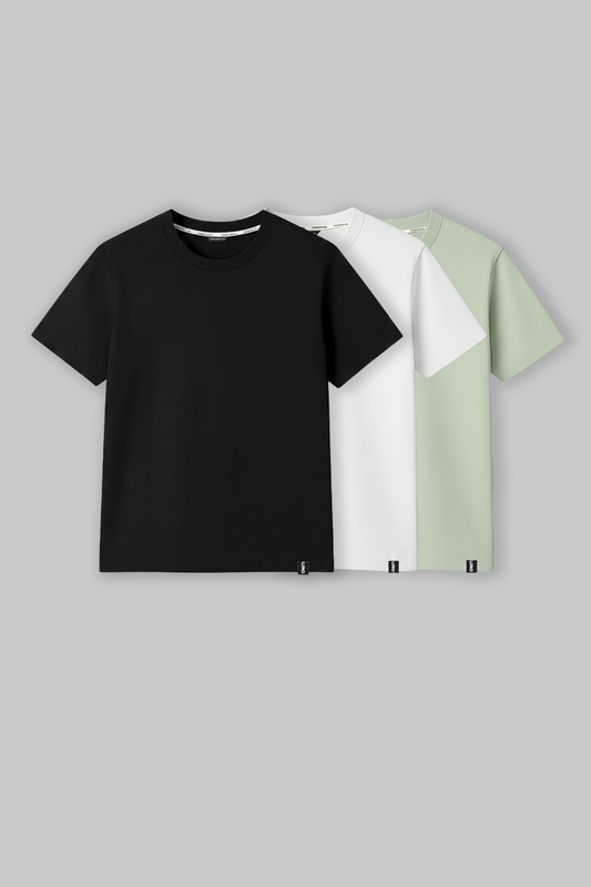 Pack of three men's crew neck t‑shirts in black, white, and mint green laid flat on a light background.
