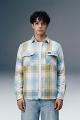 Man wearing a plaid shirt with a gray background