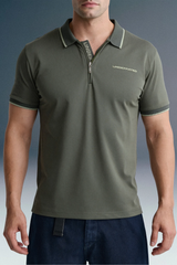 Front view from the chest up of a man standing straight, highlighting the zip-up or open placket design and contrast-striped collar of an olive green polo shirt.