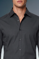 Black dress shirt worn by a person on a gradient background
