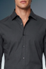Black dress shirt worn by a person on a gradient background