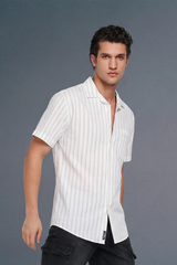Man wearing a white striped shirt against a gray background