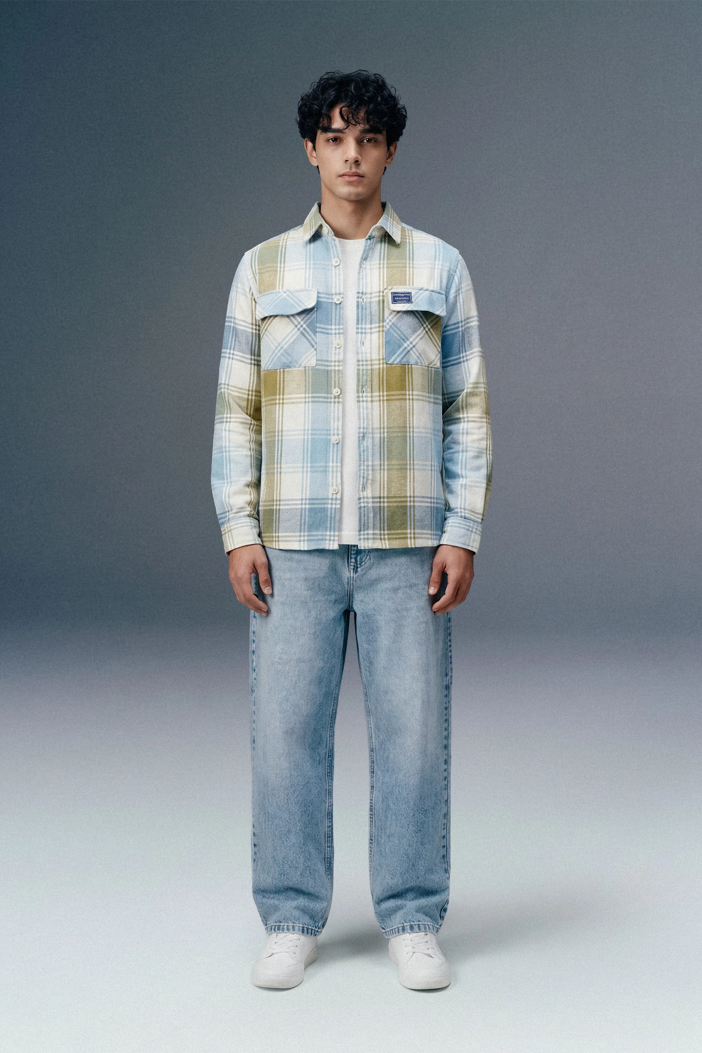 Person wearing a plaid shirt and jeans on a gray background