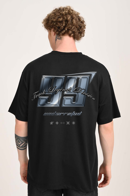 Back view of a man with curly hair wearing an oversized black t-shirt with a metallic-look graphic that reads "99 Track Legends Division".