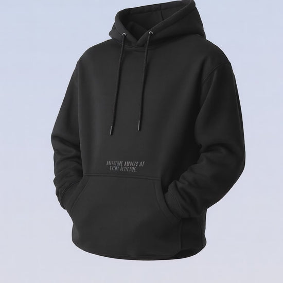 Black pullover hoodie with drawstrings and a subtle dark text print on the chest.
