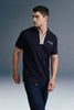 A dynamic, close-up angled shot from the chest up focusing on the arm and torso of a man leaning forward in a navy blue polo shirt with beige collar detailing.